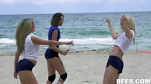 Beautiful American women enjoy a risqué beach volleyball game